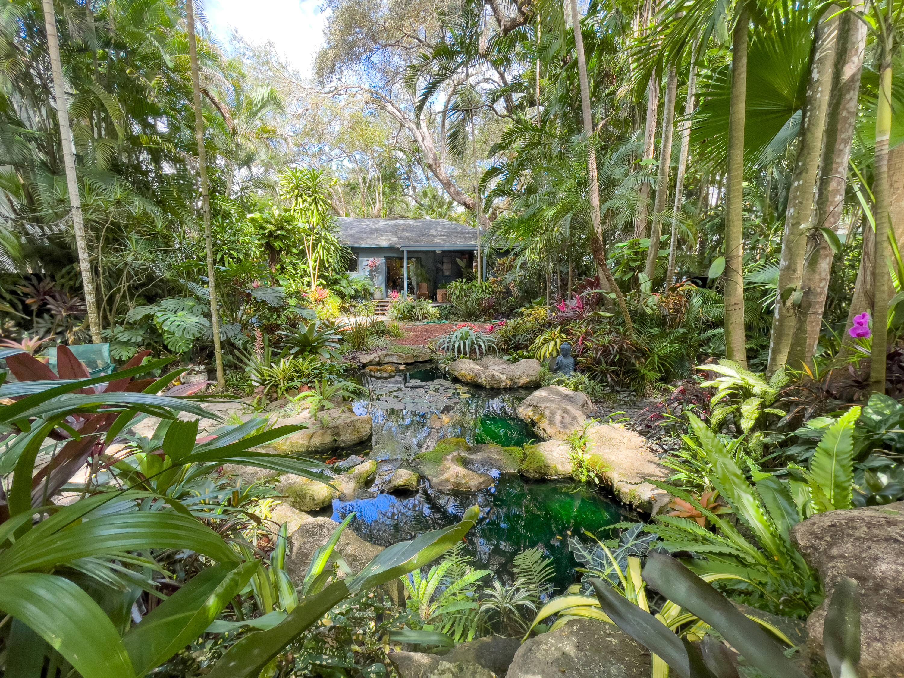 Imagine living within this exotic Coconut Grove wonderland, resplendent with dozens of towering palms, four majestic oaks, and bamboo.