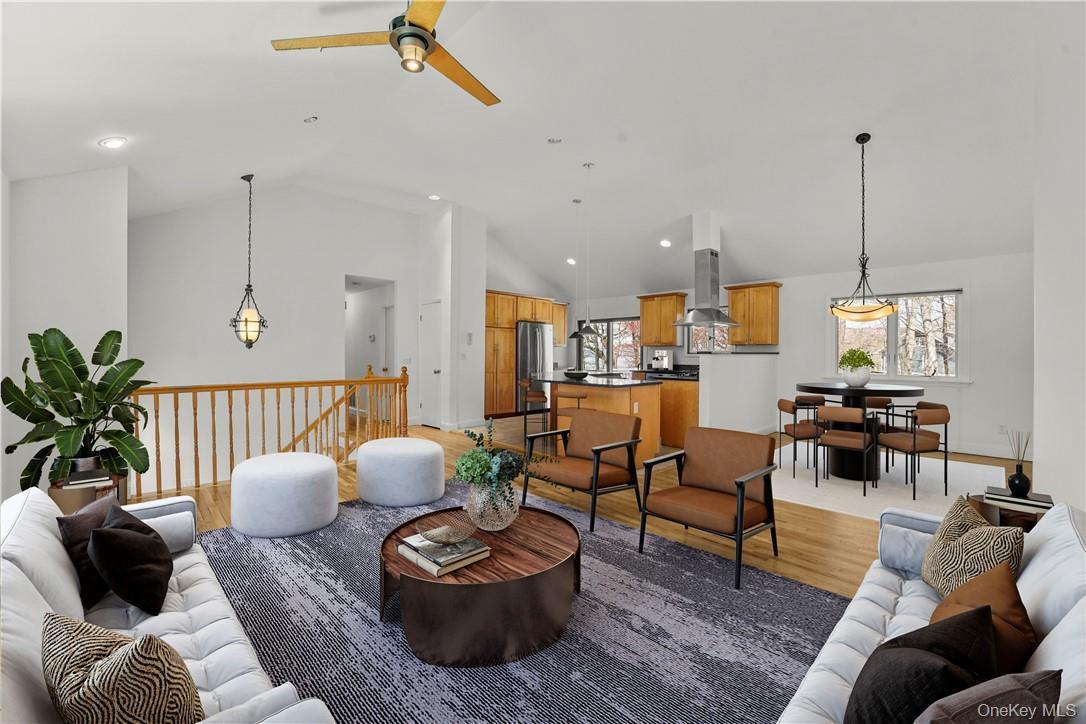 Virtually staged view of the living room, dining room and kitchen.