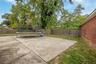 Fenced backyard with a trampoline and a patio area