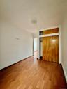 Unfurnished bedroom with wood finished floors and a closet