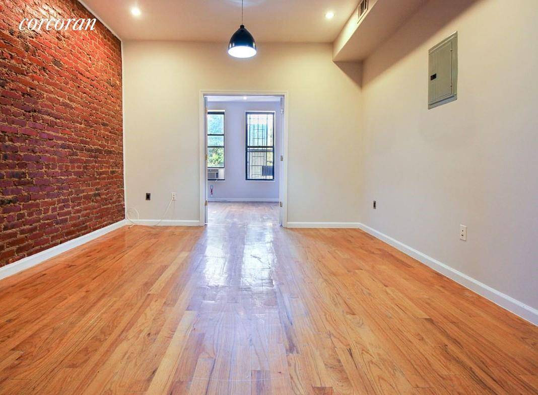 Exposed brick walls Large common area living room space Cozy kitchen with stainless steel appliances and modern cabinetry One 1 lovely full bathroom with tub and shower Beautiful hardwood floors ...