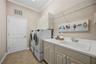 Laundry room with cabinet storage and sink