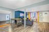 Living area with light wood finished floors, radiator heating unit, and a baseboard heating unit