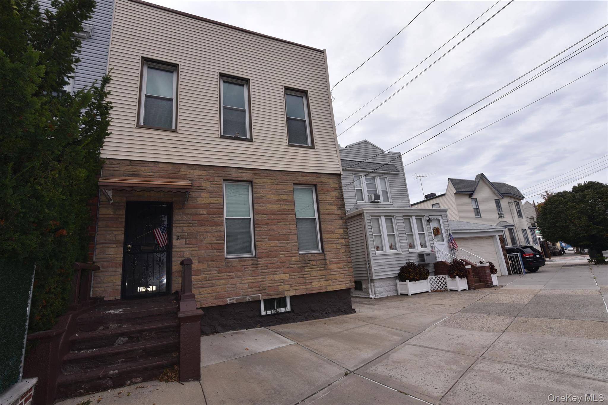 Discover the potential of this semi attached two family home located in the heart of Glendale, Queens.