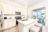 Open concept kitchen with quartz countertops and stainless steel appliances in Margaritaville Resort Orlando