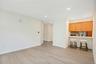 Open-concept living/ dining space featuring European white oak flooring and breakfast bar