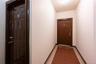 Doorway to outside featuring tile patterned floors and baseboards