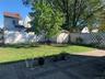 Fenced backyard featuring a storage shed and a patio