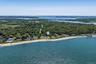 Bird's eye view of unending shoreline and a heavily wooded area