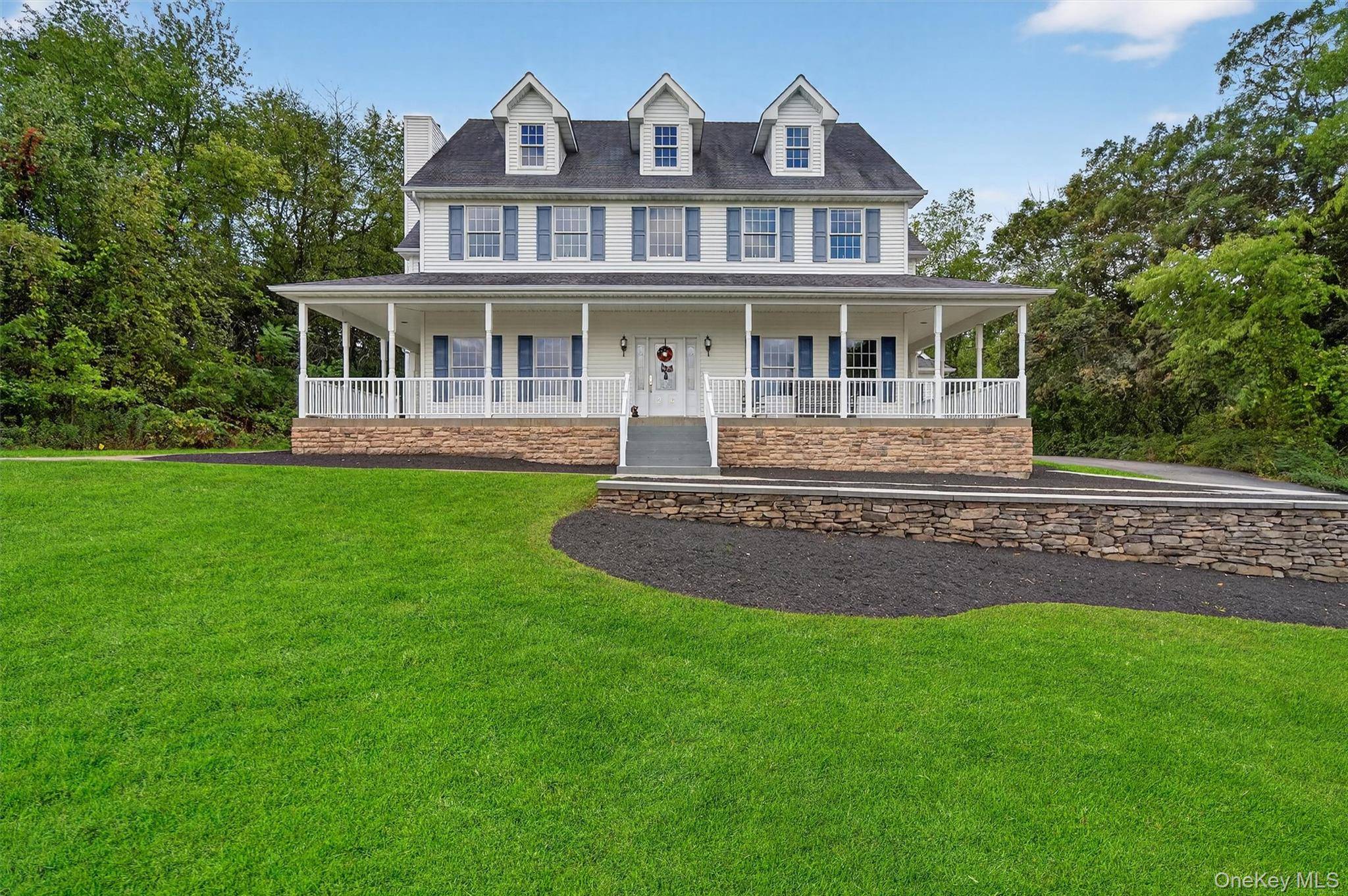 Perched gracefully on a gentle hilltop in the peaceful Goshen countryside, this custom built Colonial offers commanding panoramic views and an unmatched sense of privacy.