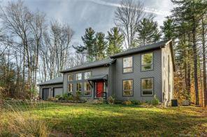 Located on a quiet cul de sac at Woodridge Lake, this contemporary home sits on 1.