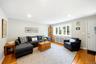 Living area featuring hardwood flooring, recessed lighting, and a multi-pane window with a radiator cover below