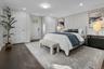 Primary bedroom with private exterior entrance offering convenient access to the yard and outdoor living space.