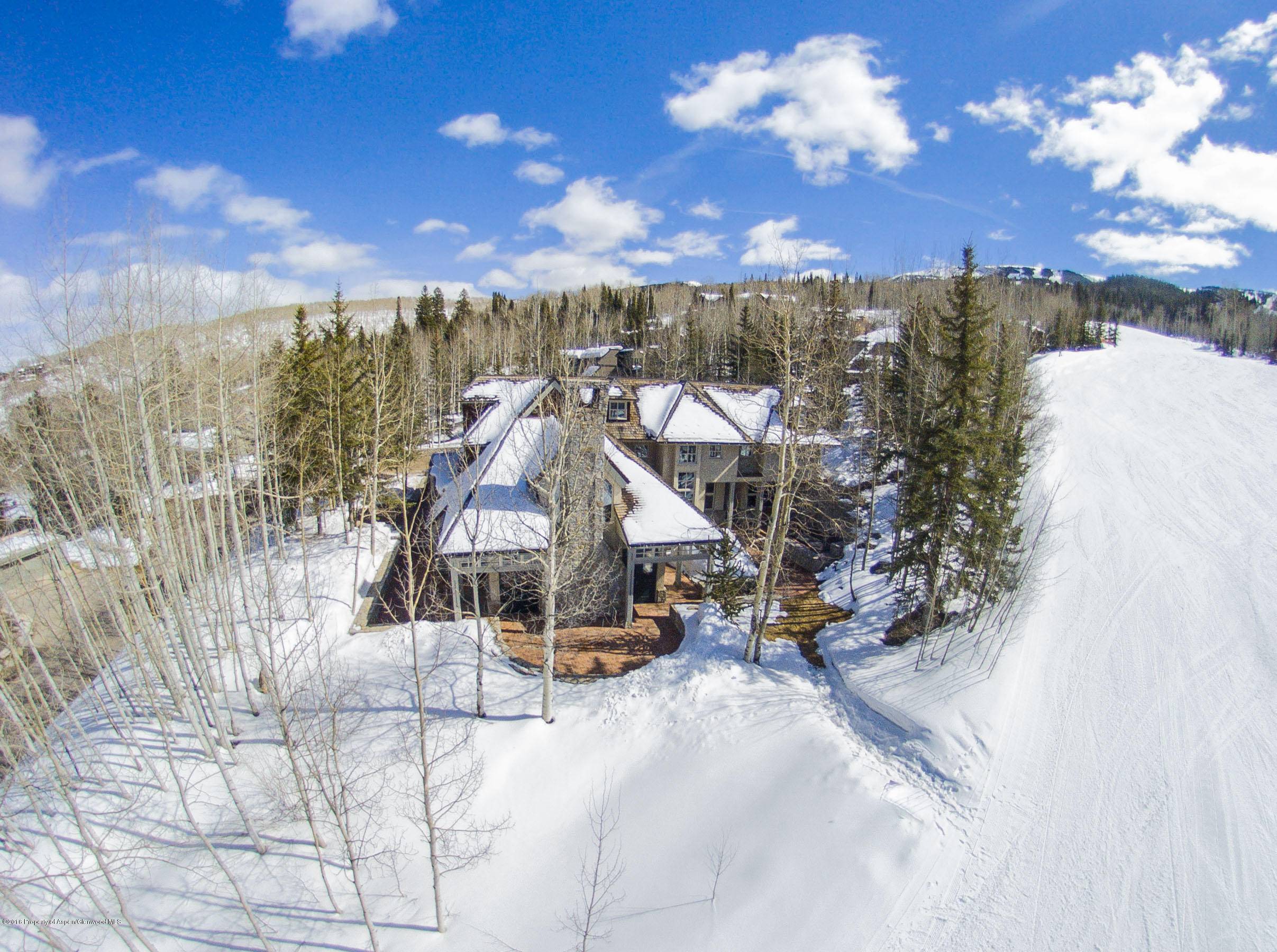 Finely crafted stone and stucco home that sits directly on Adam's Avenue ski run.