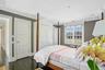 Bedroom featuring ornamental molding, dark wood-type flooring, and recessed lighting