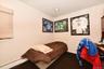 Carpeted bedroom with crown molding and a baseboard radiator