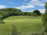 View of property's community with a lawn