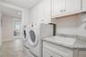 Laundry room with built-in cabinetry and utility sink.