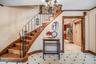 Staircase featuring a chandelier, crown molding, and elevator