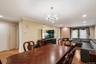 Expansive living area with wood-finish flooring, recessed lighting, and crown molding