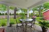 Wooden deck featuring outdoor dining space, a fenced backyard, and area for grilling