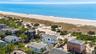 Drone / aerial view featuring a beach view and a water view