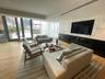 Living area with wood finished floors and recessed lighting