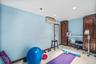Exercise room with tile patterned floors, a wall mounted AC, and recessed lighting