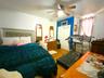 Bedroom featuring wood finished floors and ceiling fan