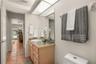 Guest bathroom featuring a spacious vanity and walk-in shower