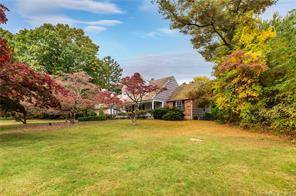 Welcome home to this charming Colonial Cape with in ground pool on a private, beautiful acre in North Stamford.
