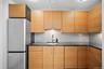 Kitchen with freestanding refrigerator, a sink, and tasteful backsplash