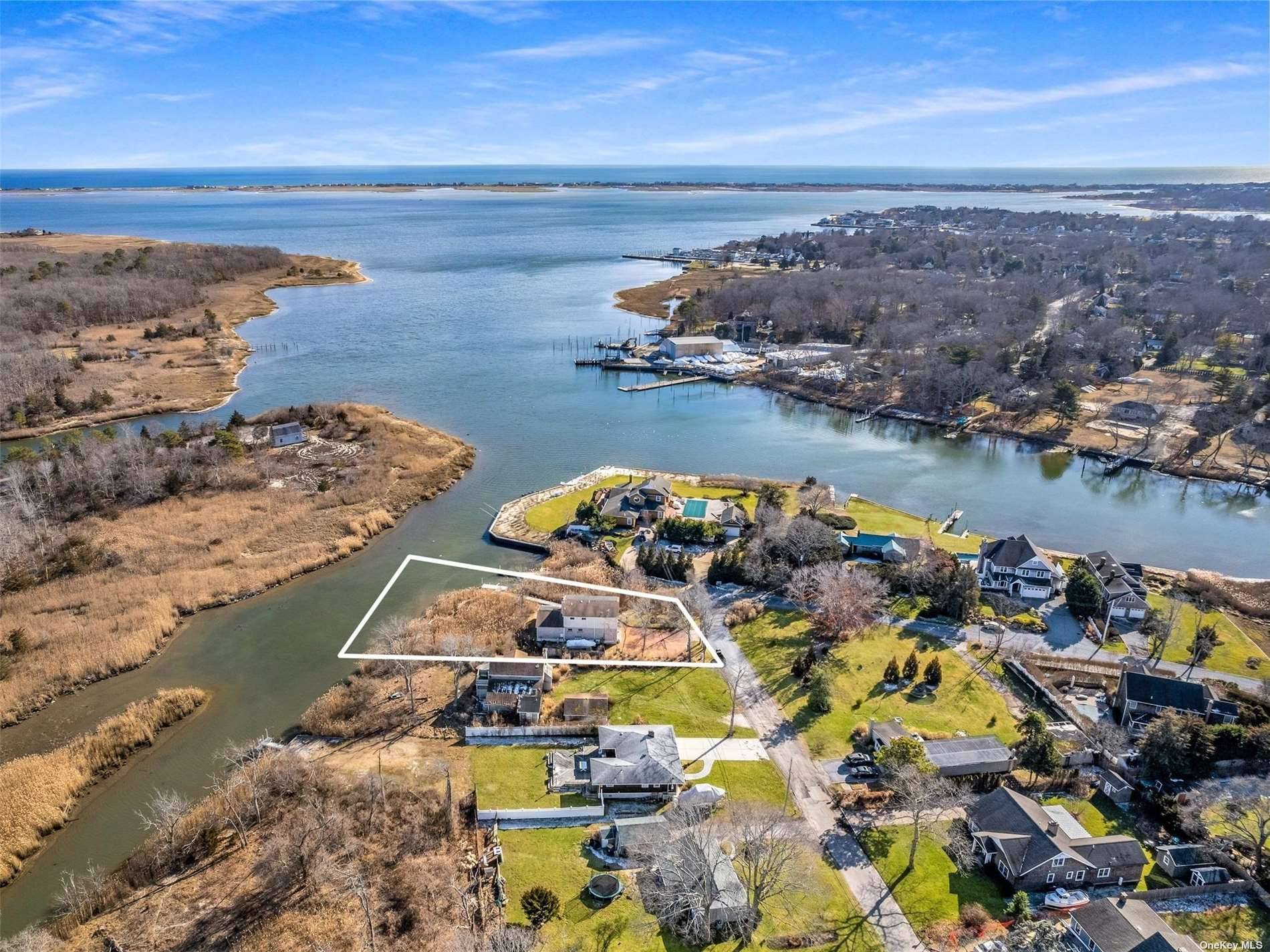 Located on Weesuck Creek and overlooking Shinnecock Bay, 13 Bayberry Lane in East Quogue is a private hidden gem close to the heart of town.