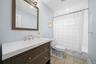 Full bathroom featuring vanity, shower / bath combo, light tile patterned floors, and recessed lighting