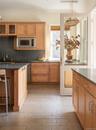 Kitchen featuring backsplash, a kitchen breakfast bar, stainless steel appliances, dark stone countertops, and ornamental molding