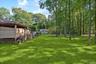 View of grassy yard featuring a deck