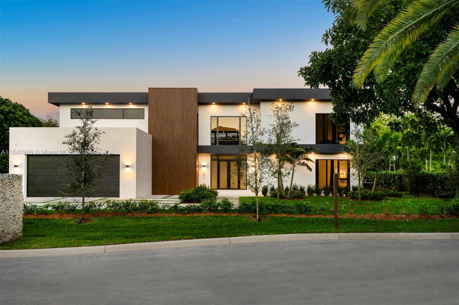 In a tranquil cul de sac, this new contemporary corner home offers an airy, open layout with high ceilings and natural light located in North Pinecrest.