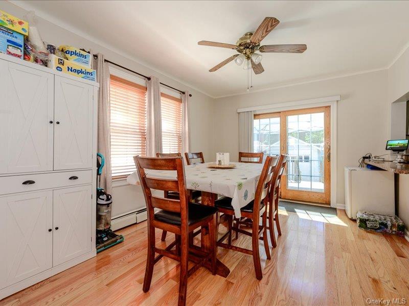 Dining area with hardwood flooring, a ceiling fan, and French doors providing exterior access