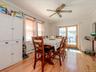 Dining area with hardwood flooring, a ceiling fan, and French doors providing exterior access