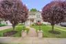 Two-story residence featuring expansive paver stone entry walkway