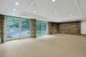 Rarely found and impossible to replicate, the spectacular walk-out lower level showcases authentic exposed stone walls, luxury vinyl flooring, and dra