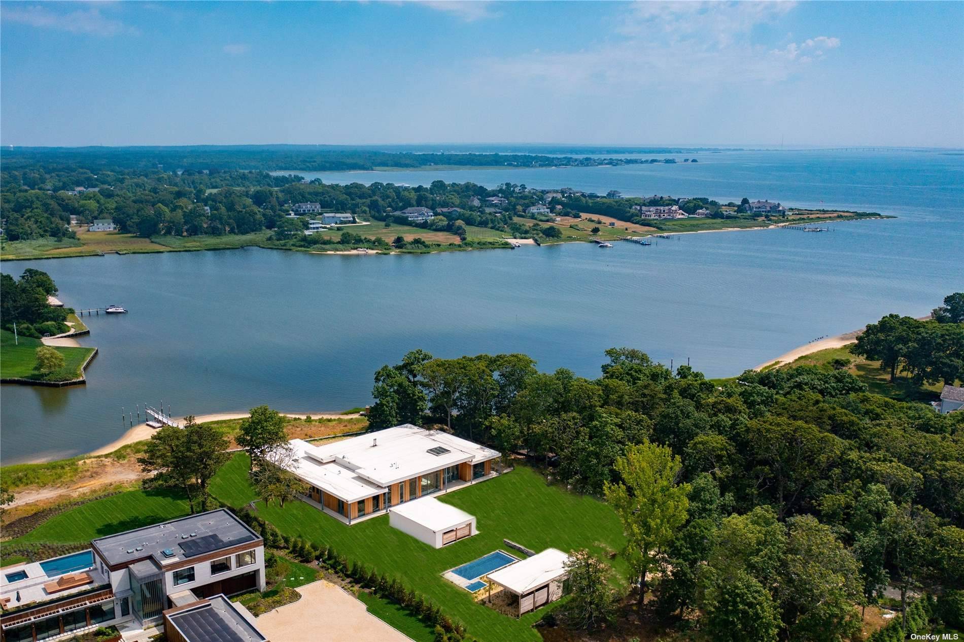 Enjoy high end modern design, single level living and stunning waterfront views in this almost completed new construction featuring a seven bedrooms, pool, spacious cabana and boat dock.
