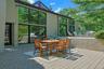 This spacious patio, perfect for al fresco dining, blurs the line between indoors and outdoors, enhancing the home's modern design and connection to
