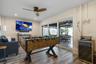 Ground level gameroom and sliding doors to the covered patio and pool deck