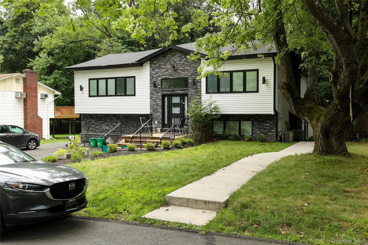 Contemporary facade with horizontal siding and stacked stone accents