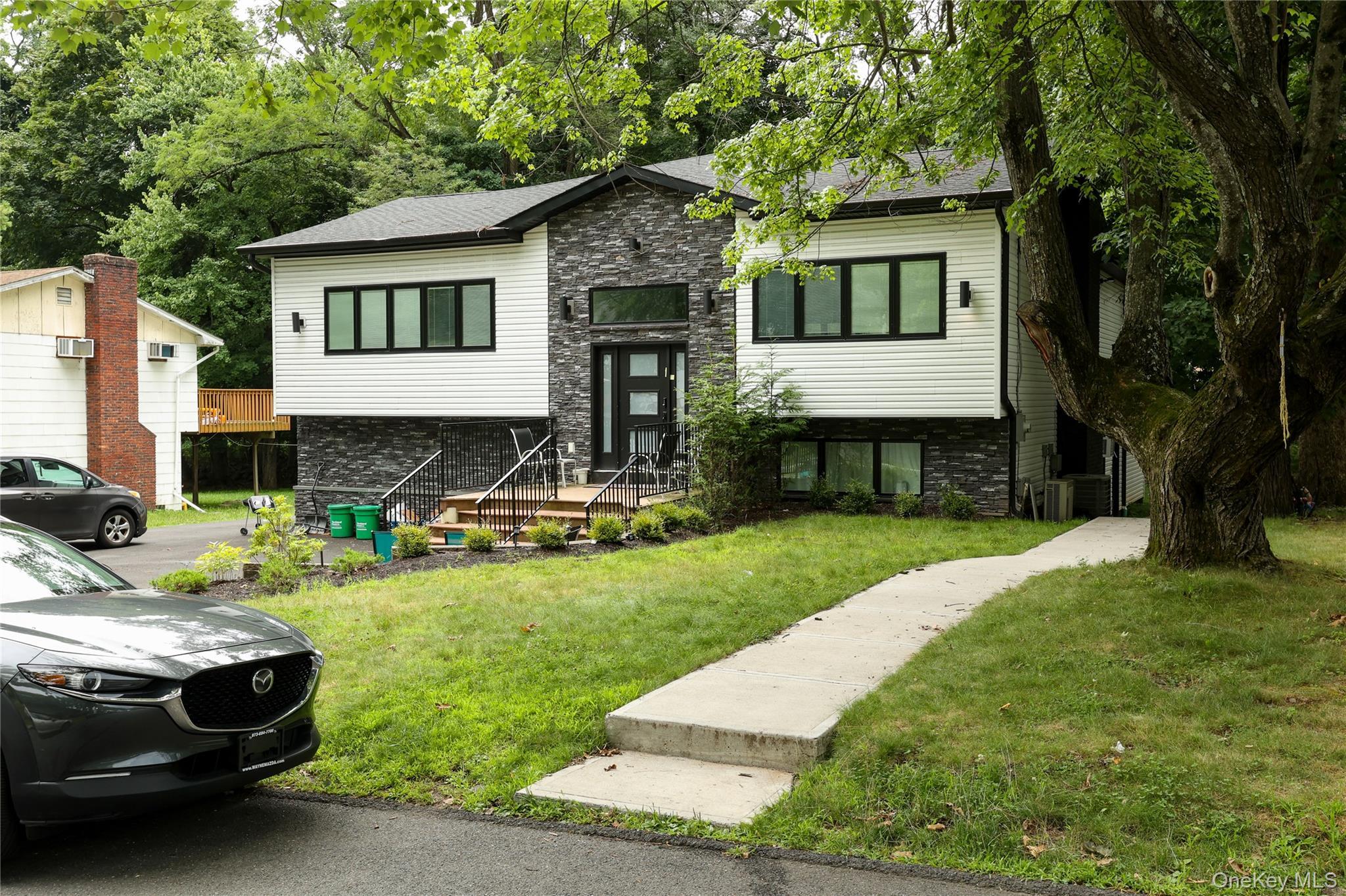 Contemporary facade with horizontal siding and stacked stone accents