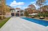 View of swimming pool featuring a fenced backyard, a patio, and a sunroom