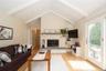 Family room with vaulted ceiling and sliding doors to backyard