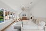 Bedroom with wood finished floors, recessed lighting, and lofted ceiling
