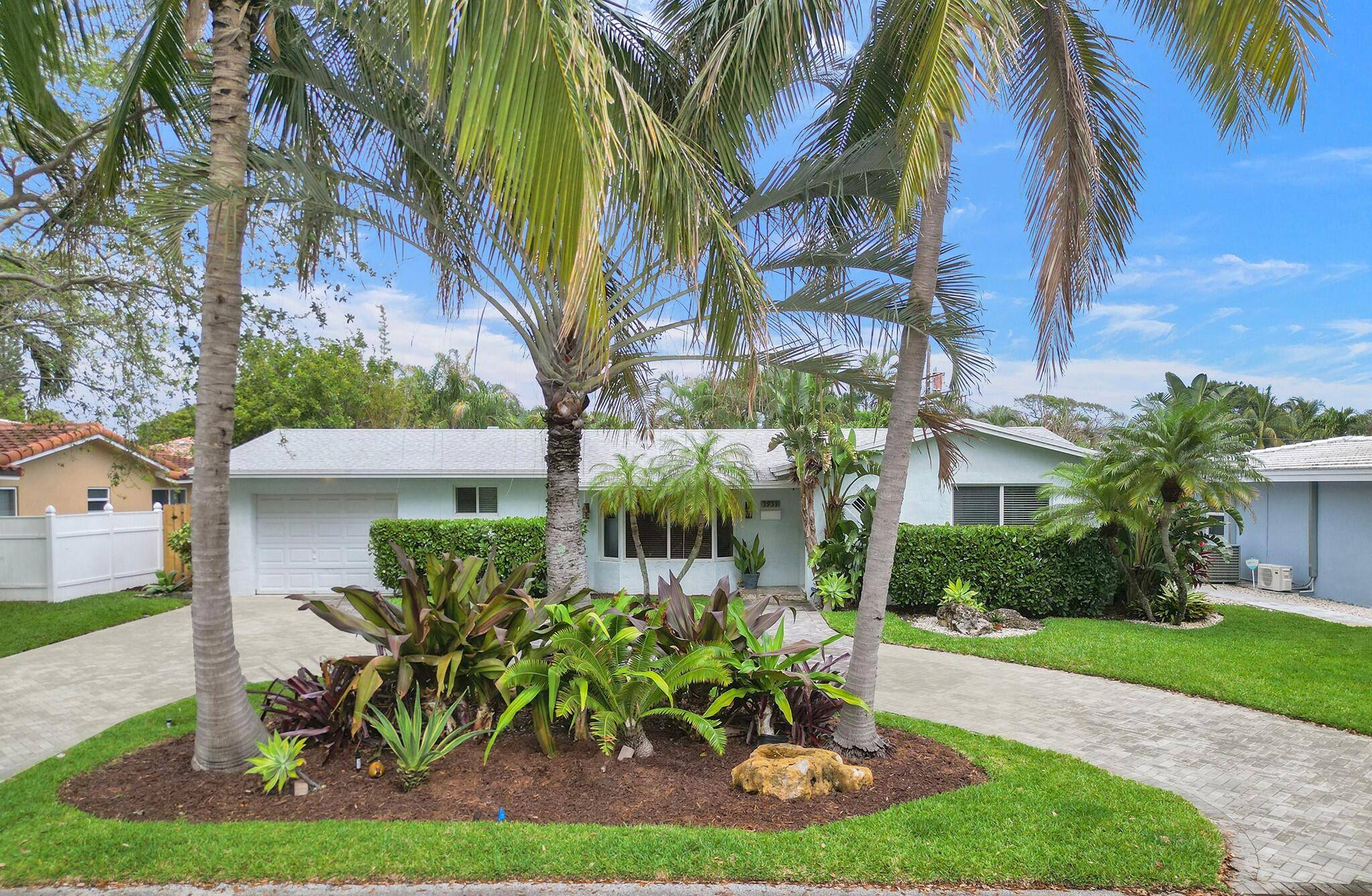 Coastal elegance welcomes you as you step inside this light and bright single family home located on a quiet, oak tree lined street in the heart of prestigious Lighthouse Point.